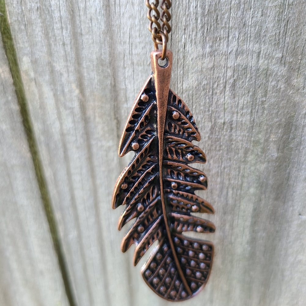 Feather pendant necklace and matching earrings